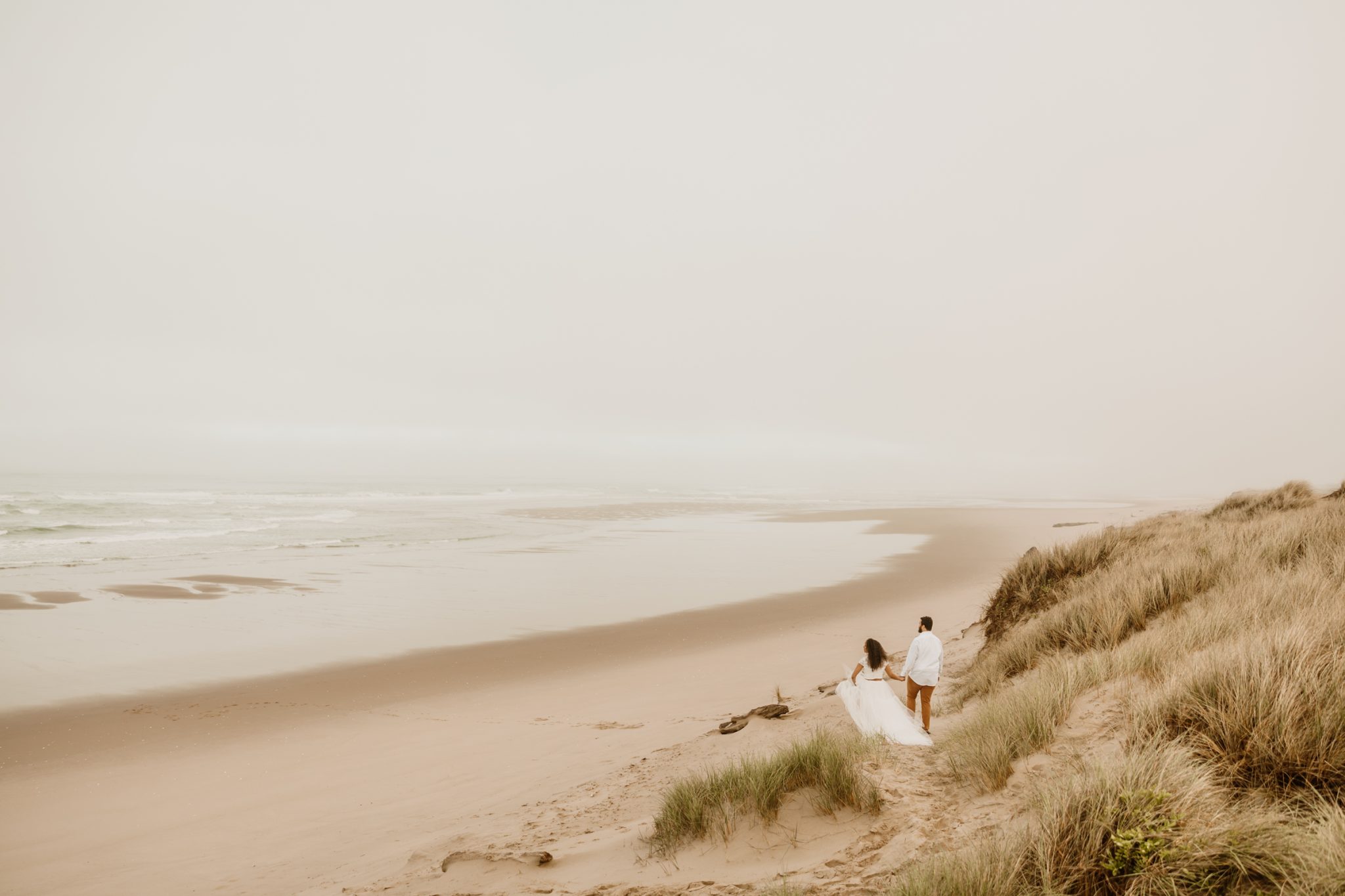 Walking on the Florence beaches in a beautiful wedding dress