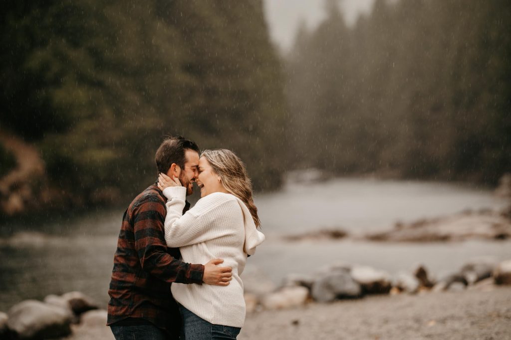 A couple embrace by a misty river at Golden Ears