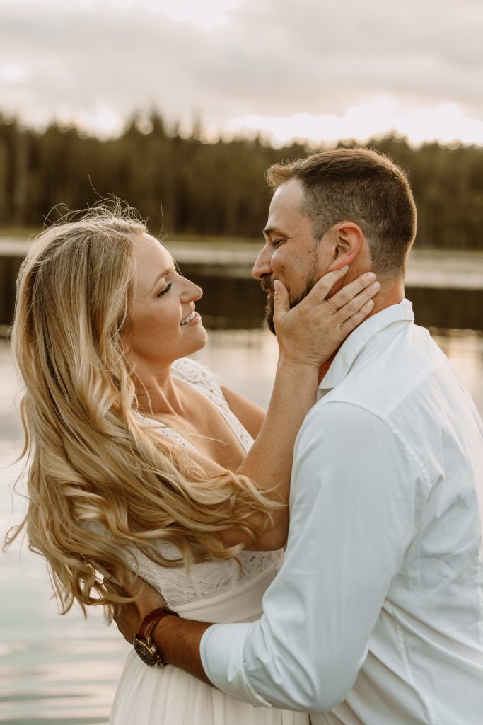 Intimate moment amidst tranquil lily pads, natural outdoor engagement session