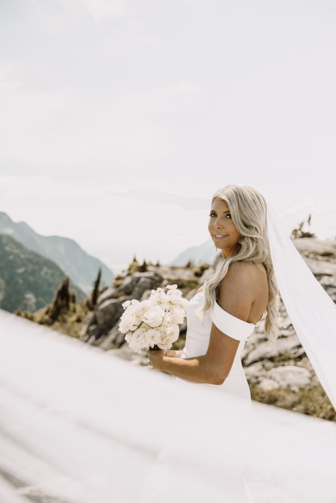Helicopter elopement at the top of the mountain peeks over the fraser valley. Helicopter flight with Sky helicopters. bridal portraits