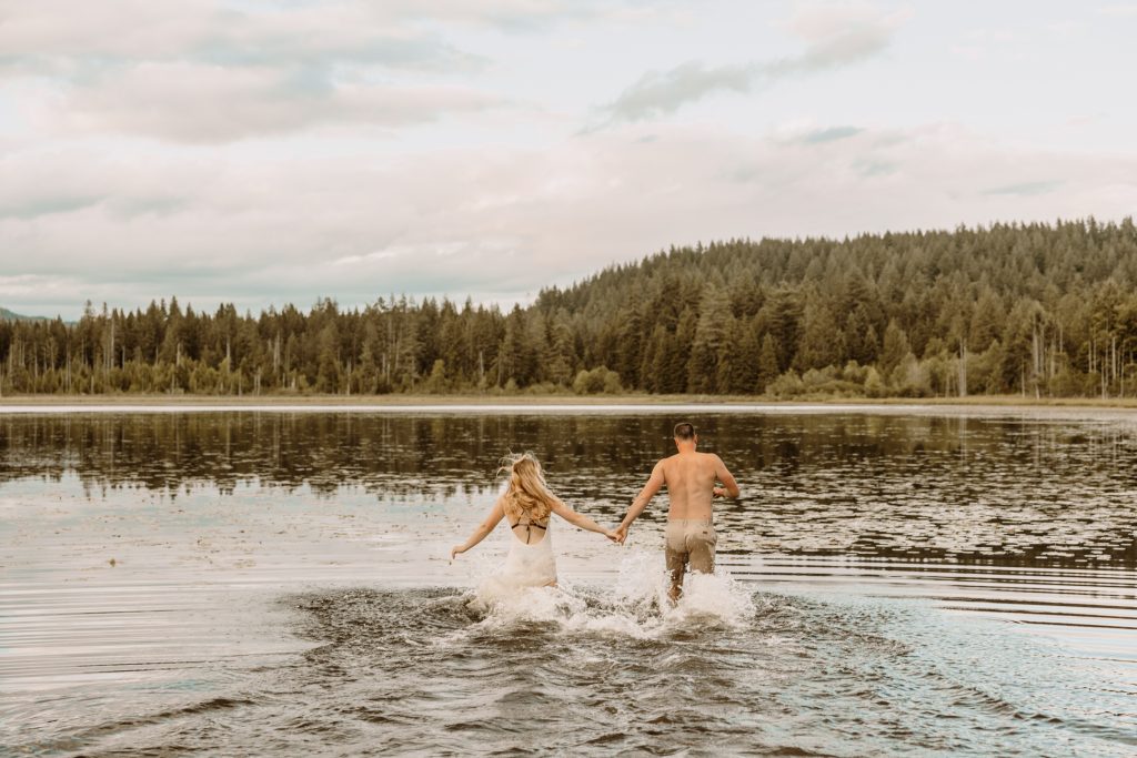 Genuine moments of connection by the lake's golden glow, candid engagement photography