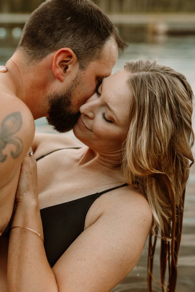 Intimate moment amidst tranquil lily pads, natural outdoor engagement session