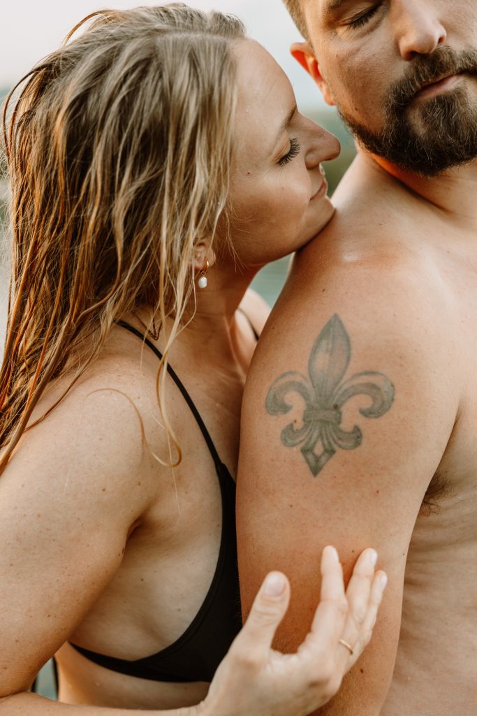 Intimate moment amidst tranquil lily pads, natural outdoor engagement session