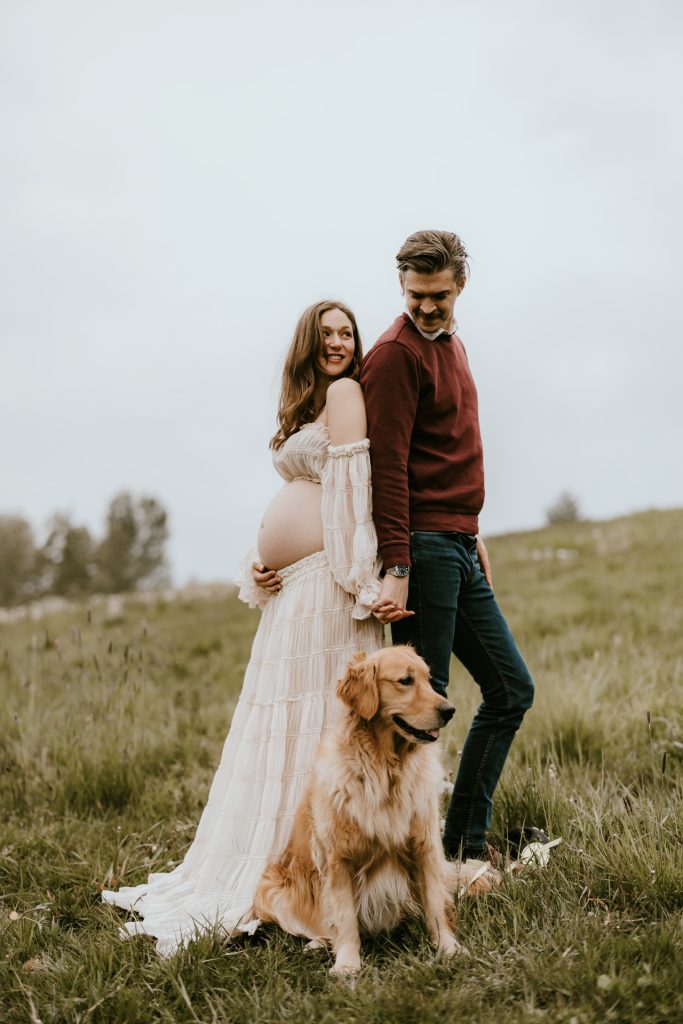 Glowing pregnant woman in a picturesque Fraser Valley meadow, highlighting the beauty of pregnancy in nature.