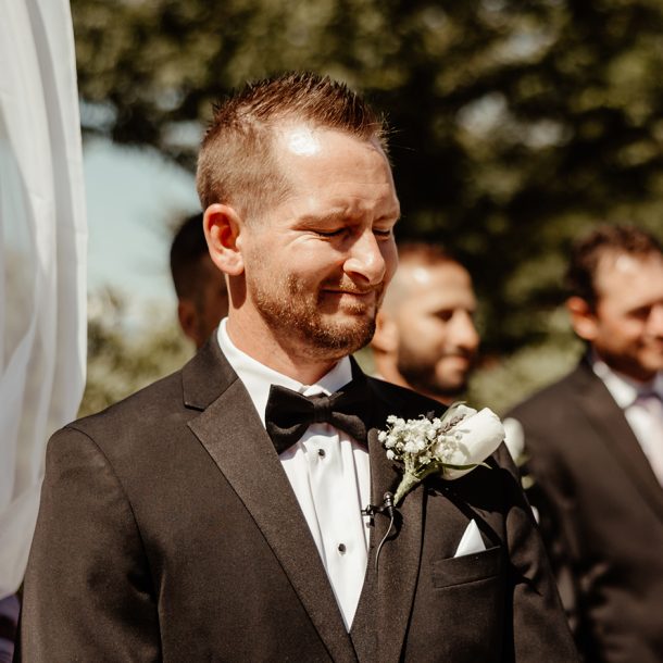 Groom on wedding day emotional at the aisle