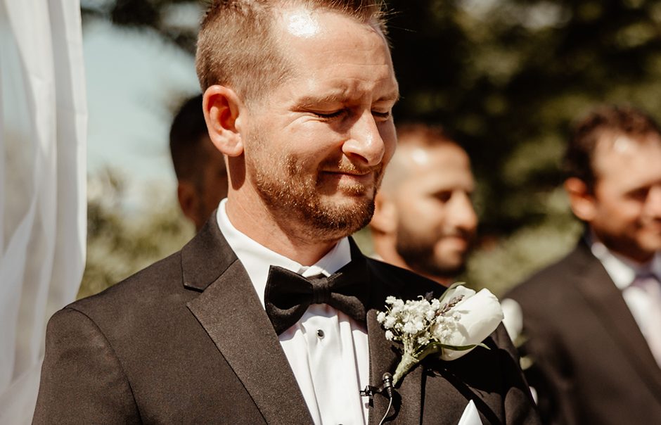 Groom on wedding day emotional at the aisle