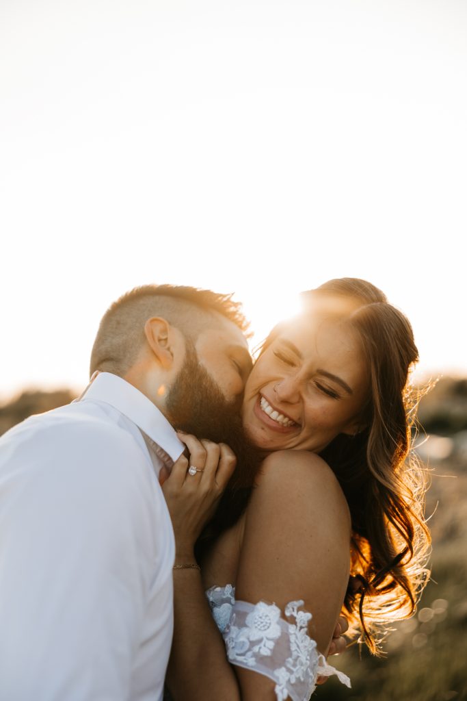 Ocean front elopement with bride and groom laughter and playful moment