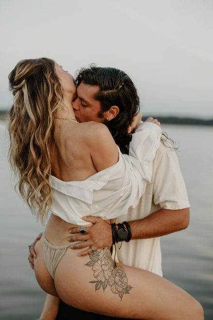Close-up of bikini-clad couple sharing an emotional embrace in the sea at Mud Bay Vancouver