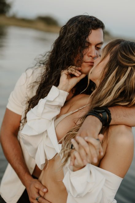 Artistic water portrait of couple intertwined in the sea during Vancouver beach session