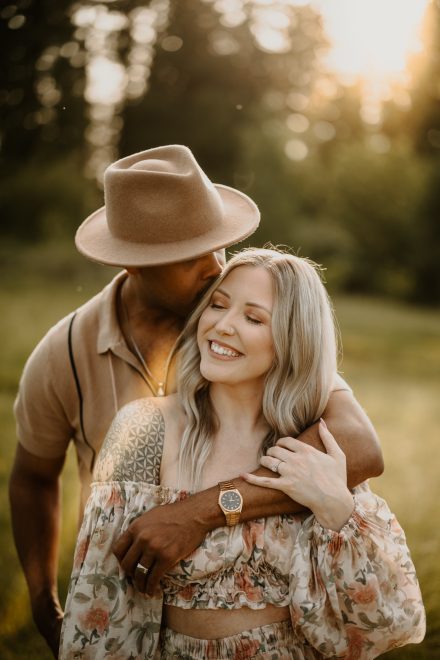 Candid couple’s photo of mom and dad laughing in soft golden light