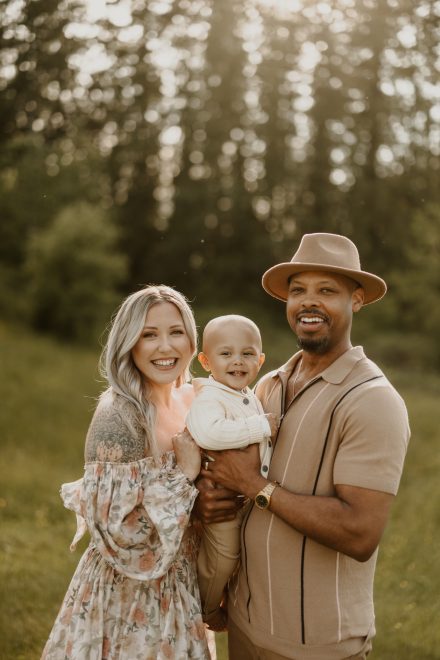 Tender family portrait in golden light, full of soft smiles and connection
