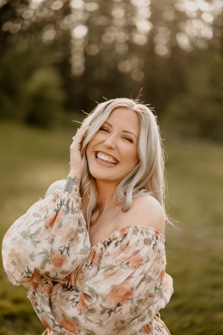 Elegant solo photo of mother in tall grasses during golden hour with warm, natural light