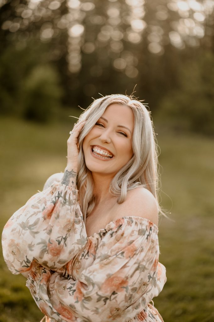 Elegant solo photo of mother in tall grasses during golden hour with warm, natural light