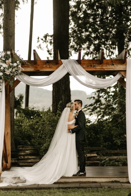 The kiss—newlyweds sealing their vows against stunning BC backdrop