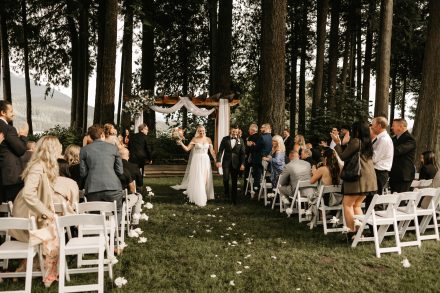 Bride and groom walking back down the aisle hand-in-hand as newlyweds