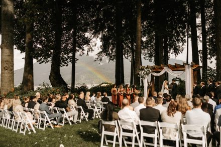 Wide angle of ceremony setup at Rowena’s on the River with mountains and water behind