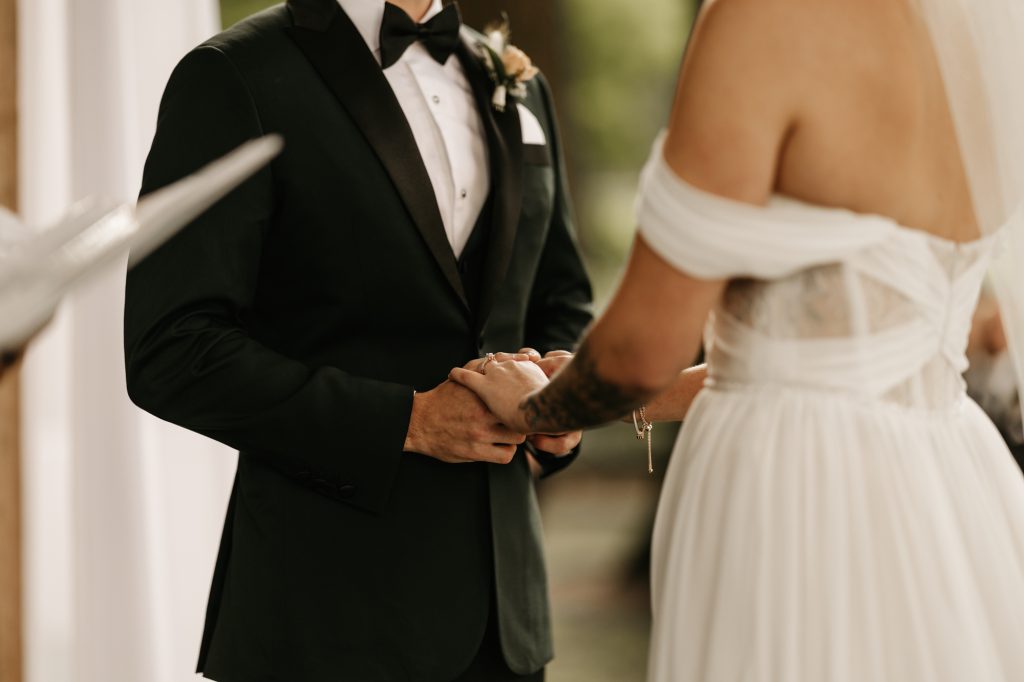 Couple exchanging vows with emotional expressions and joyful tears