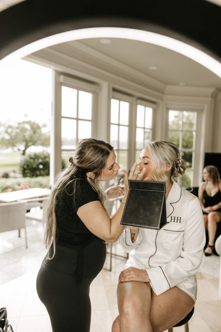 Candid moment of bride preparing for the day, surrounded by quiet anticipation
