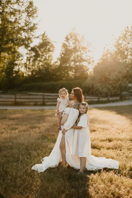 Natural maternity photography in BC meadow with stunning evening light and warmth
