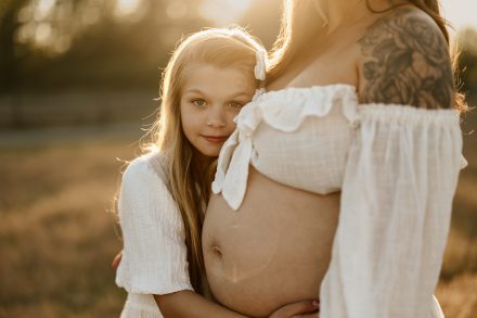 Outdoor maternity portrait at Blackie Spit featuring elegant gown and peaceful landscape