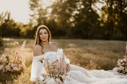Radiant maternity portrait in soft light surrounded by wild grasses at Blackie Spit BC