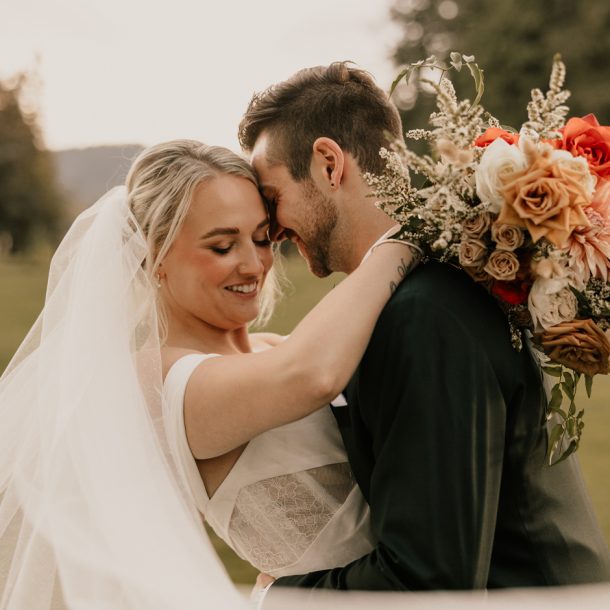 Romantic outdoor wedding ceremony at Rowena's on the River with mountain backdrop in Fraser Valley