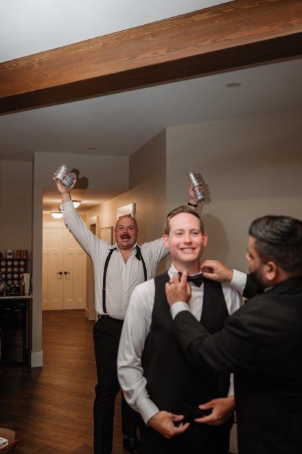 Groom Parker getting ready with his groomsmen before his family backyard wedding in Abbotsford