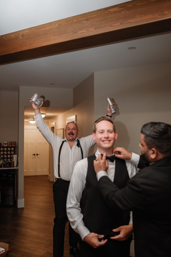 Groom Parker getting ready with his groomsmen before his family backyard wedding in Abbotsford