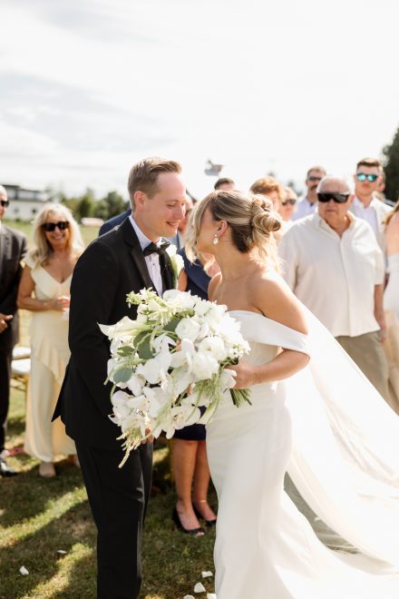 Parker and Melissa sharing a funny, almost kiss moment as they met at the front of the isle