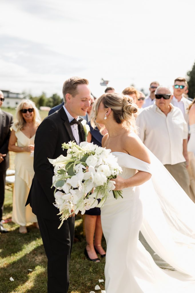 Parker and Melissa sharing a funny, almost kiss moment as they met at the front of the isle