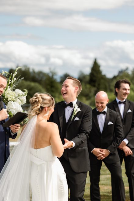 Melissa and Parker holding hands during vows at their Abbotsford summer wedding