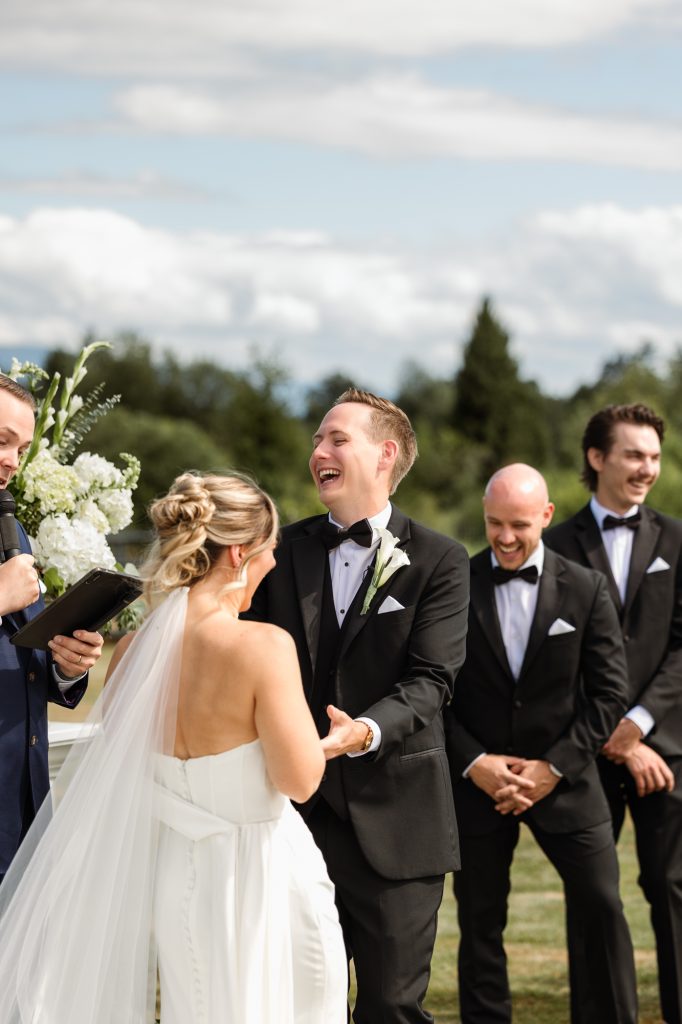 Melissa and Parker holding hands during vows at their Abbotsford summer wedding