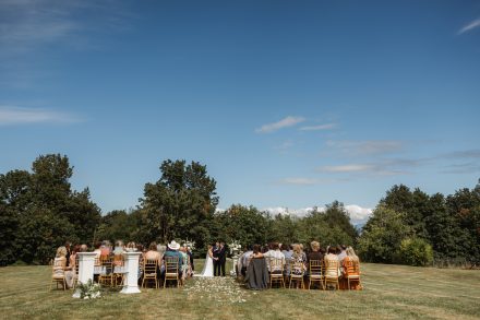 Outdoor ceremony under natural light at a family backyard wedding, officiated by The Rev Collective