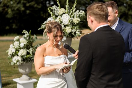 Melissa and Parker holding hands during vows at their Abbotsford summer wedding