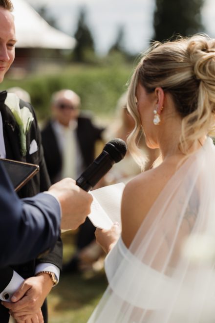 Outdoor ceremony under natural light at a family backyard wedding, officiated by The Rev Collective