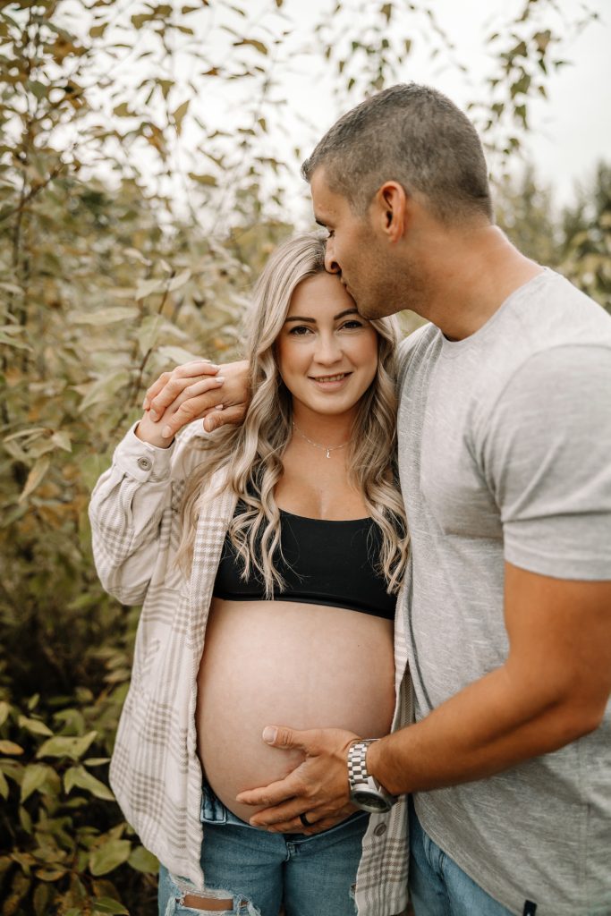 Mother-to-be walking through a sunlit field in the Fraser Valley