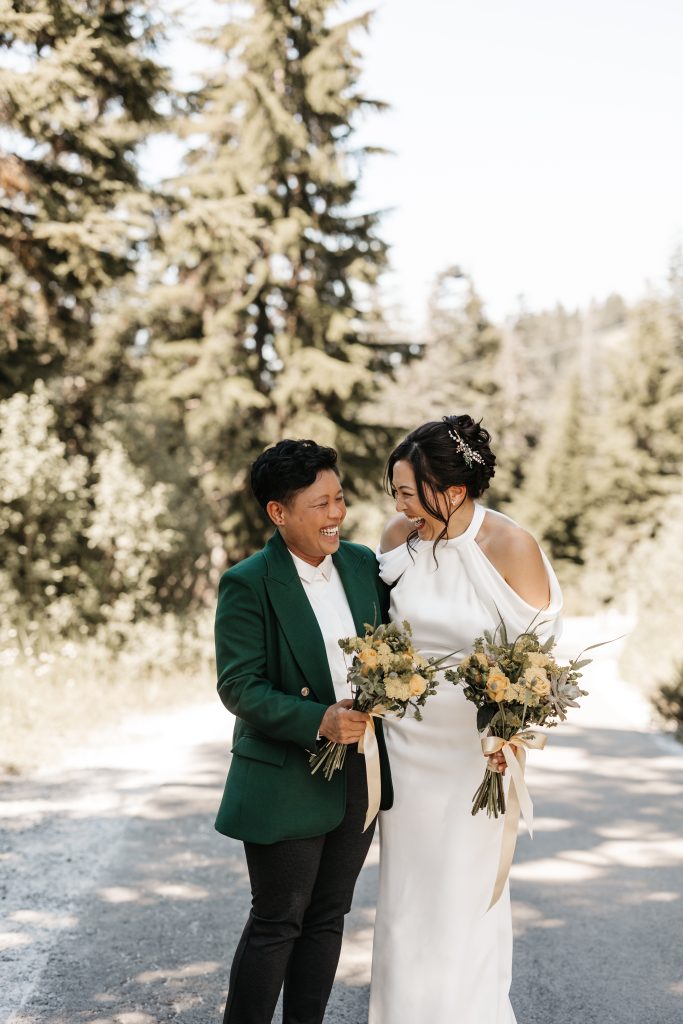 Bride laughing with her bridesmaid on Grouse Mountain