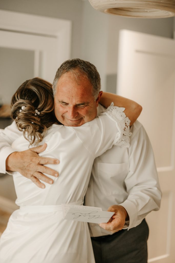 Emotional embrace between a bride and her dad