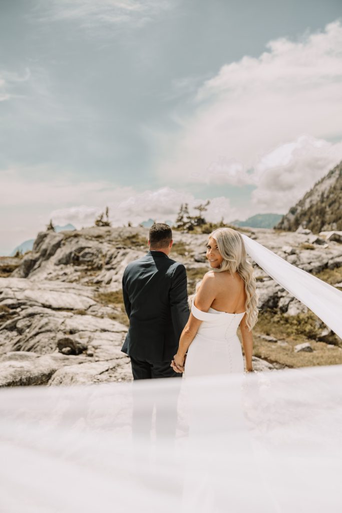 Kim on a mountaintop above the Fraser Valley on her helicopter elopement day
