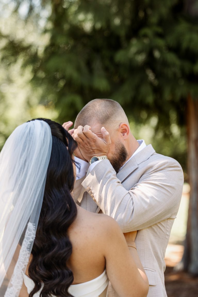 A groom wipes his eyes as he sees his bride for the first time